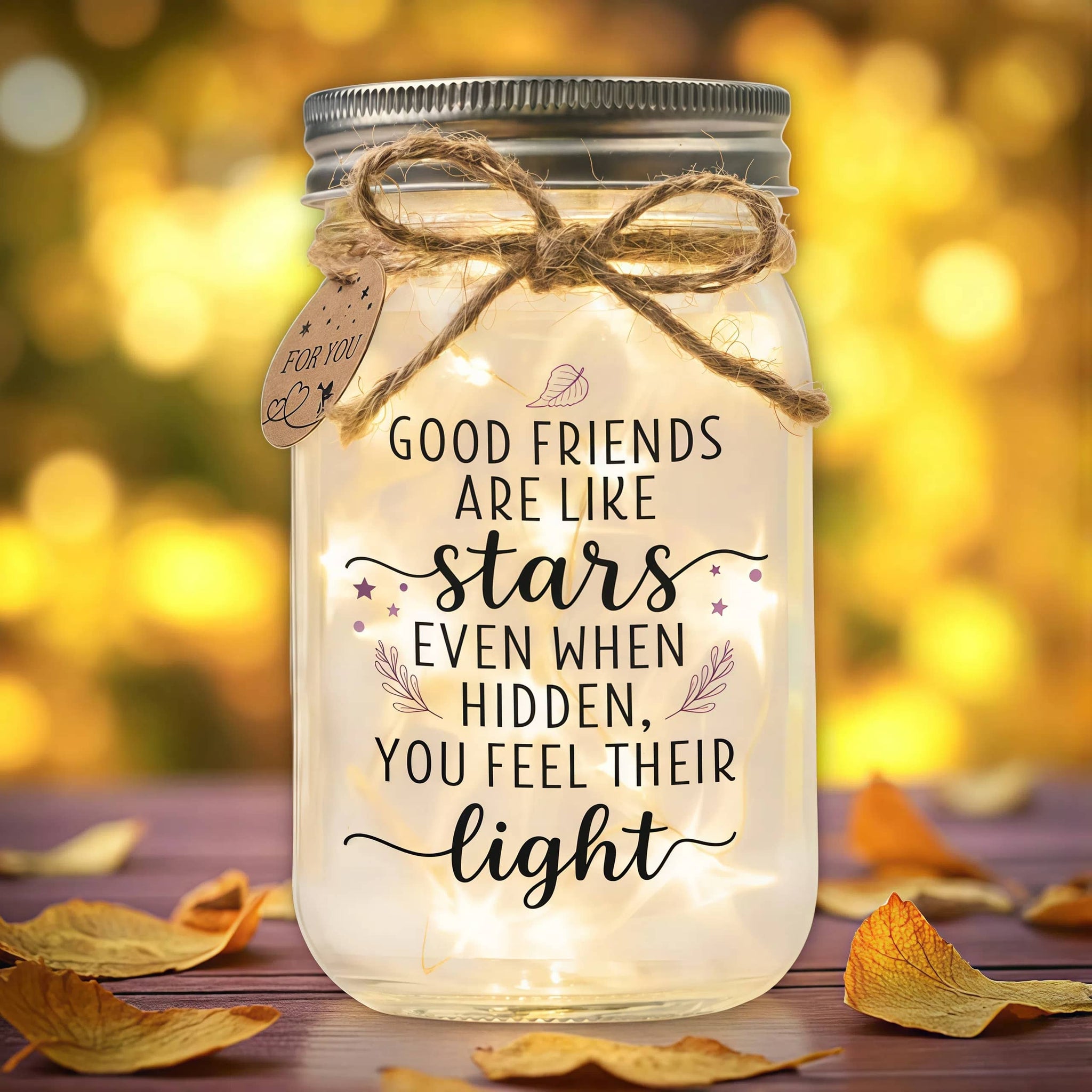 Warm-glow Mason Jar Light With The “Good Friends are Like Stars” design. Clear glass, pre-lit LEDs, gift-ready lid with twine bow and tag.