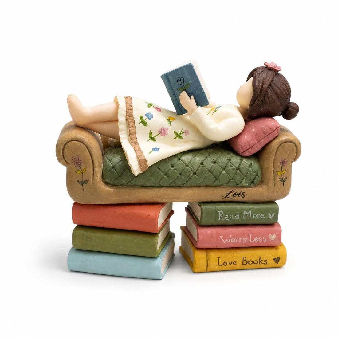 Girl Reading on a Tiny Sofa Clay Figurine, styled in a home setting