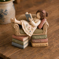 Girl Reading on a Tiny Sofa Clay Figurine, styled in a home setting (view 4)