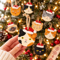 Personalized Cat Ornament, Hand-Painted to Match Your Cat, held in a hand among other cat ornaments on a tree