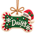 Personalized Dog Bone Ornament with Name and Santa Hat, candy-cane green design with the name Daisy