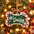 Personalized Dog Bone Ornament with Name and Santa Hat, close-up on a tree