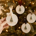 Personalized Pine Tree Clay Ornament with Name, held in a hand for scale