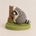 Raccoon Hugging a Tree Stump Figurine, side view (view 2)