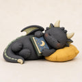 Sleeping Dragon with a Moon Book on a Yellow Pillow, on a plain background