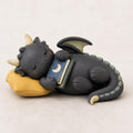 Sleeping Dragon with a Moon Book on a Yellow Pillow, on a plain background (view 2)