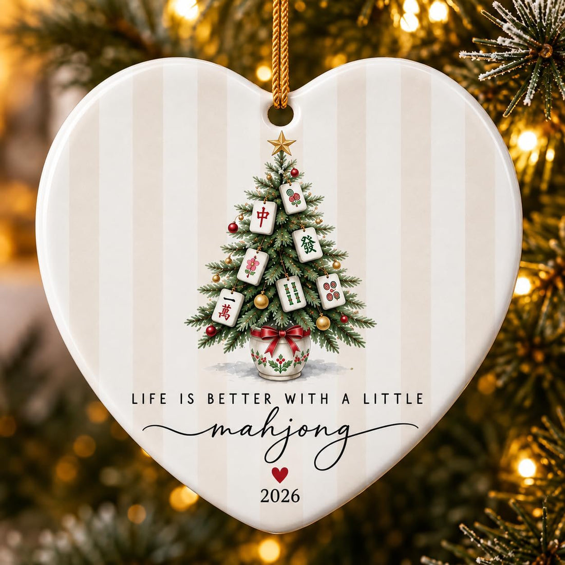 Heart-shaped ceramic ornament with a Christmas tree hung with mahjong tiles and the words Life Is Better With a Little mahjong 2026