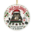 Round acrylic ornament with a cat in a Santa hat behind a rack of mahjong tiles and the words Meowjong Do Not Disturb I'm Winning