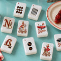 Retro Pin-Up Diner American Mahjong Set, 152 Pearl Acrylic Tiles, wind, flower and joker tiles on a teal table