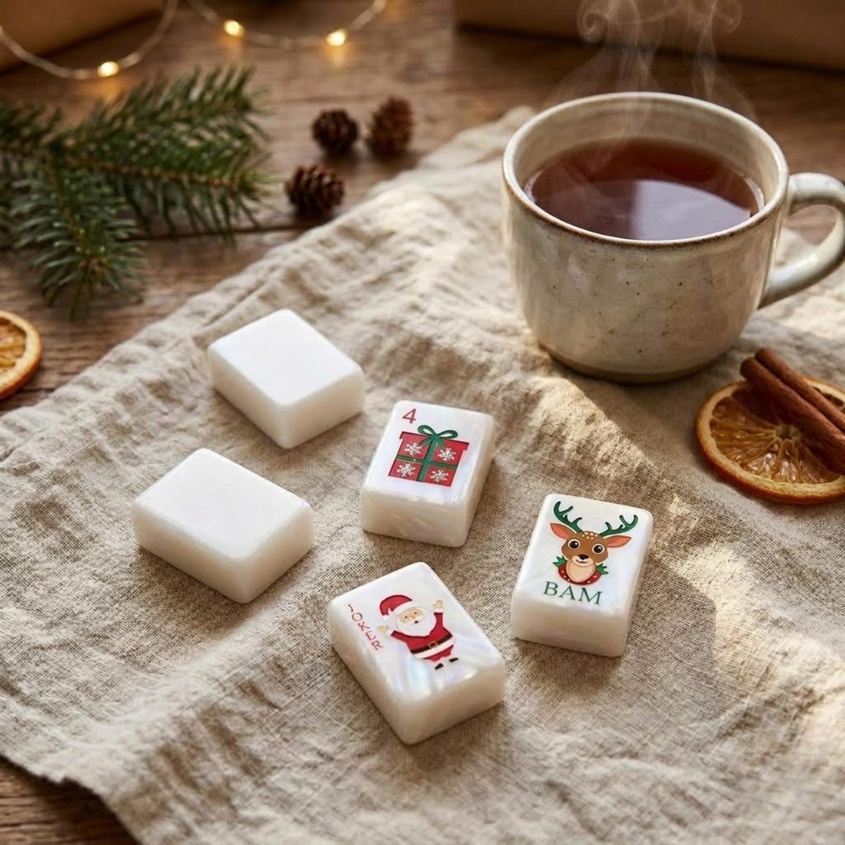 Santa and Reindeer Christmas American Mahjong Set, 152 Pearl Tiles, tiles beside a cup of tea