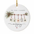 Round white ceramic ornament with five mahjong tiles on a pine garland and the words The Year I Learned mahjong